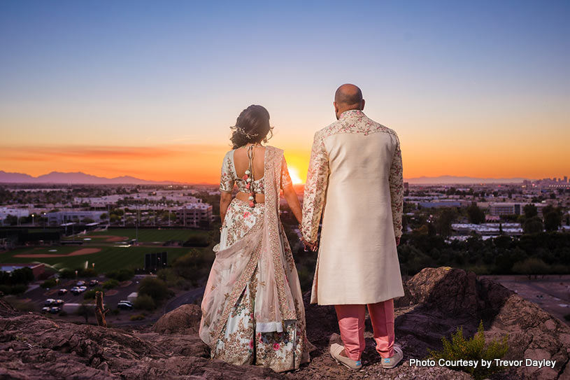 Bride and groom looking at sunset with new hopes