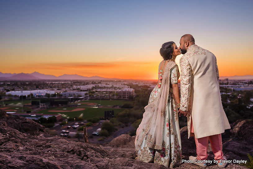 Bride and groom showing their love by kissing eavh other