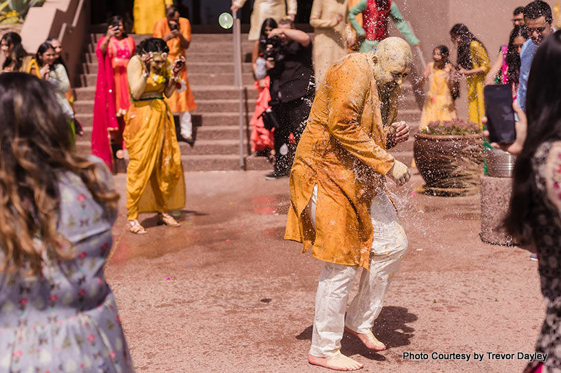 Indian bride and groom enjoying their haldi ceremony