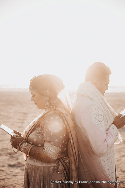 Indian bride and groom reading their notes for each other