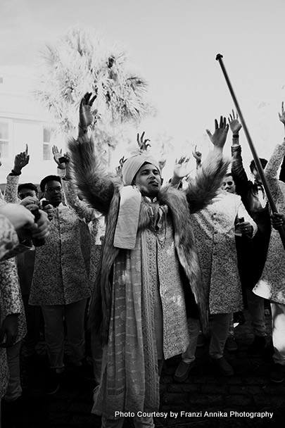 Indian gromm dancing with guest in Baraat