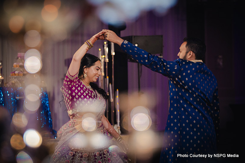 Indian wedding couple holding each others hands