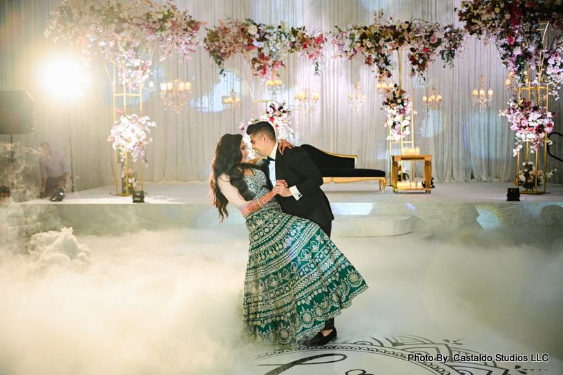 Indian bride and groom performing their dance in front of guest