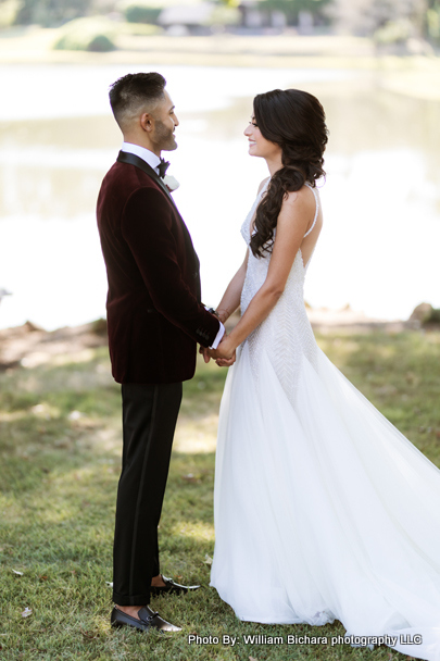 Touching moment as the bride and groom hold hands