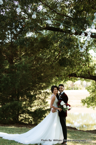 Smiling bride and groom embracing on their wedding day