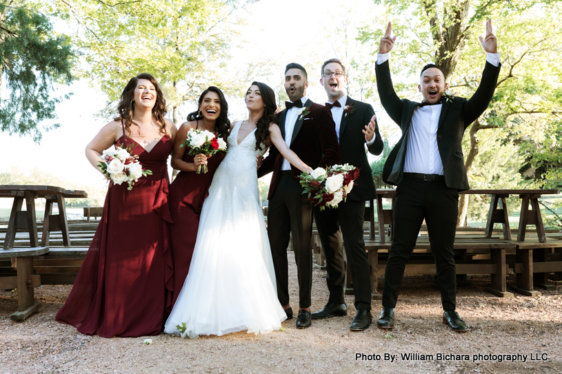 Happy bride and groom sharing a joyful moment with friends