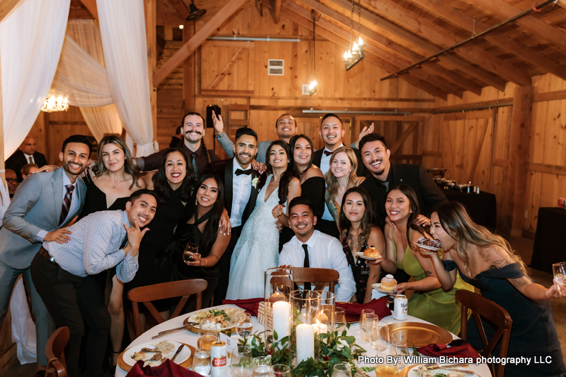 Bride and groom surrounded by friends and family