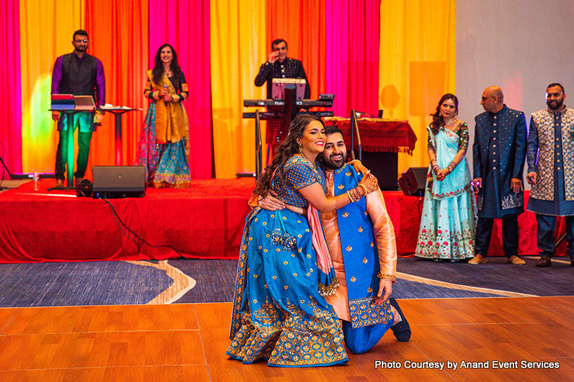 Indian bride and groom hugging tight to each other