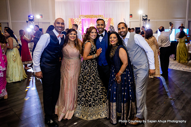 Indian bride and groom with their brother in law and sister in law capture