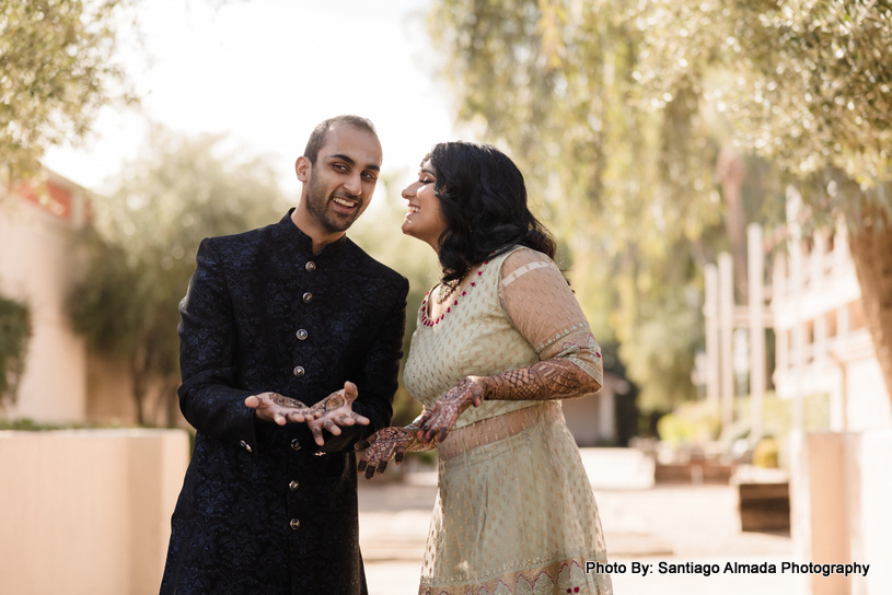 Indian couple admiring each other's mehandi designs