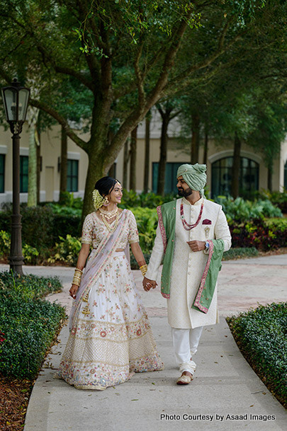 Indian wedding couple walking with holding hands