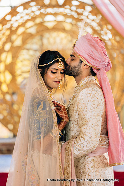 Indian Groom kissing on Indian bride's forhead