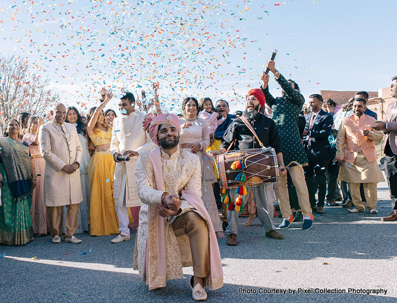  Indian groom dancing with his guest in Baraat possession