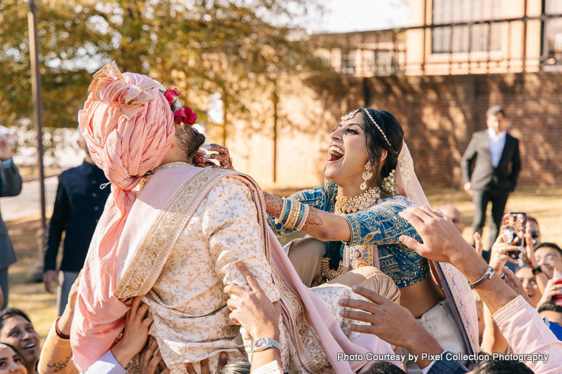 Indian bride welcoming Indian Groom by putting garland in his neck