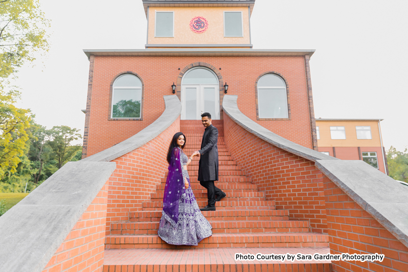 Indian wedding couple holding each others hands