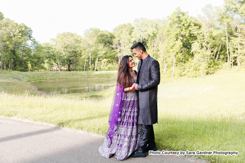 Indian wedding couple holding each others hands