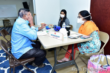 Sai Health Fair - Doctor examines Patient