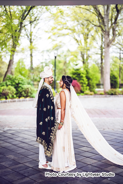 Indian wedding couple holding each others hands