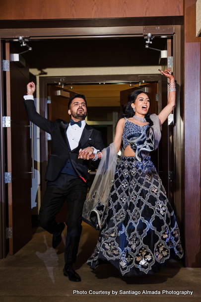 Indian wedding couple happily entering into the reception
