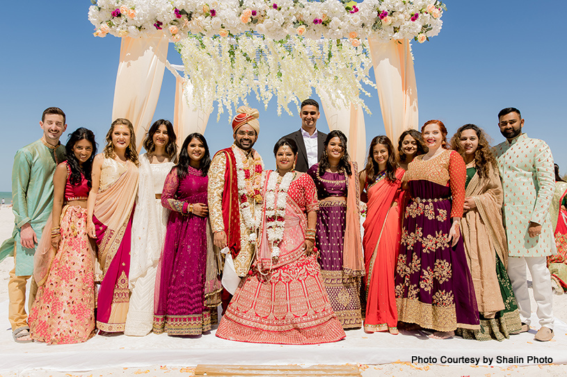 Indian wedding couple with their family members at beach