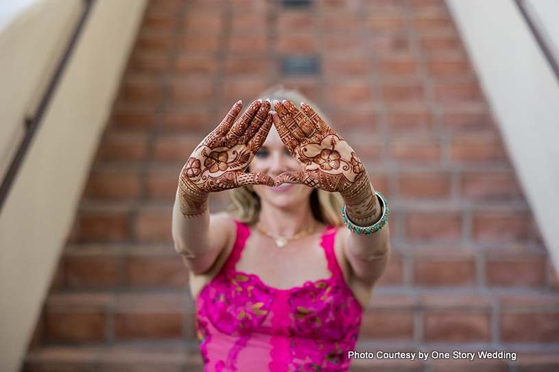 Indian wedding bride shows her mehndi design