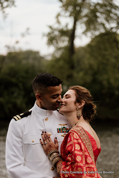 Indian bride and groom showing their love by kissing each other