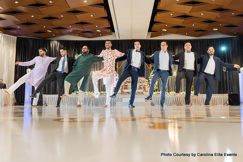 Indian groom enjoying dance with his groomsmaids