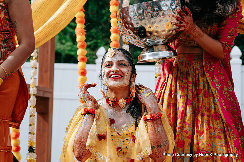 indian bride and her cousin playing with water