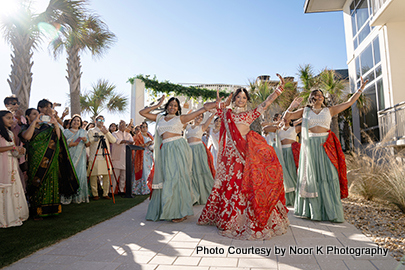 Indian bride welcoming groom with her dance
