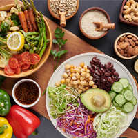 Vegan protein source. Buddha bowl dish, avocado, pepper, tomato, cucumber, red cabbage, chickpea, fresh lettuce salad and walnuts, nuts, beans, . Healthy vegetarian eating, super food.