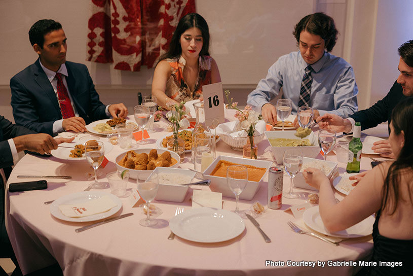 Indian wedding guest enjoying their food