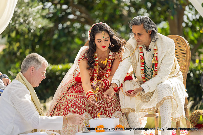 putting rice in holly fire - Indian wedding ritual