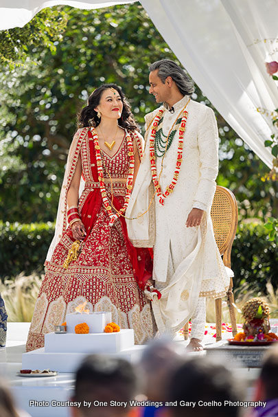 Indian wedding couple enjoying their wedding moment under wedding mandap