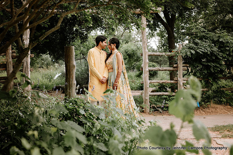 Indian wedding couple lookin into each others eyes with love