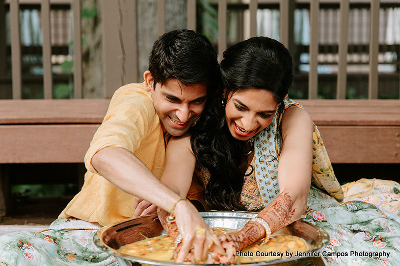 Newlyweds Indian couple playing wedding game-Indian ritual