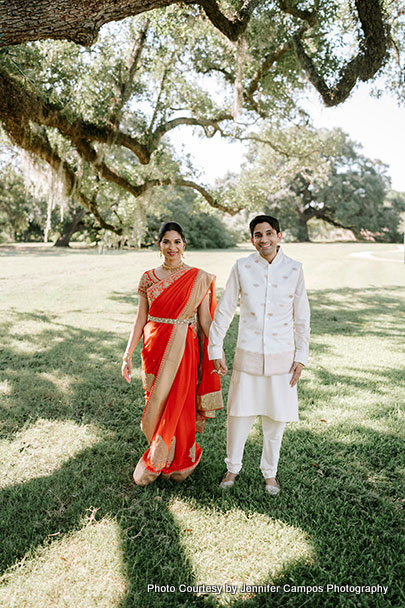 Indian wedding couple holding hands of each other and feeling happy