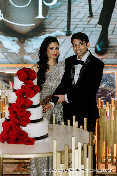 Indian wedding couple cutting their wedding cake