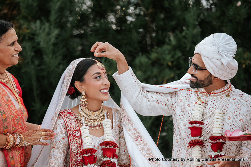 Indian Groom puttings indoor on bride's head