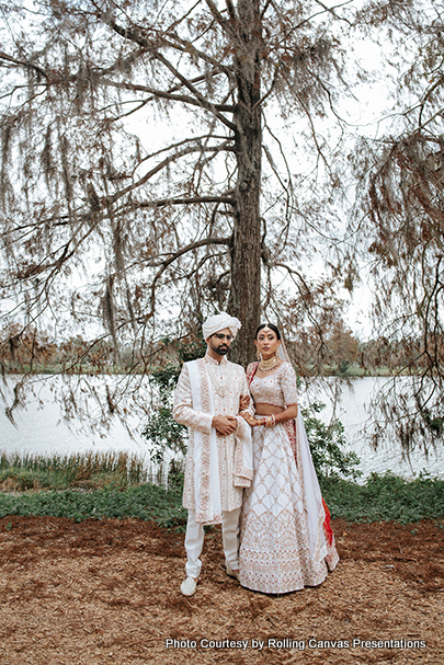 Indian Bride and groom under tree capture