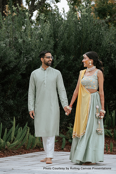 Indian Bride and groom holding hands 