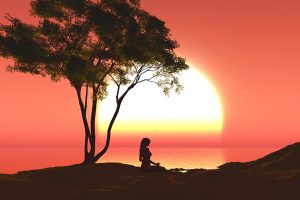 female in yoga pose under a tree 