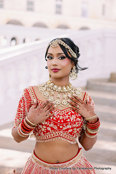 Kashmira in bridal lehenga with intricate jewelry and henna