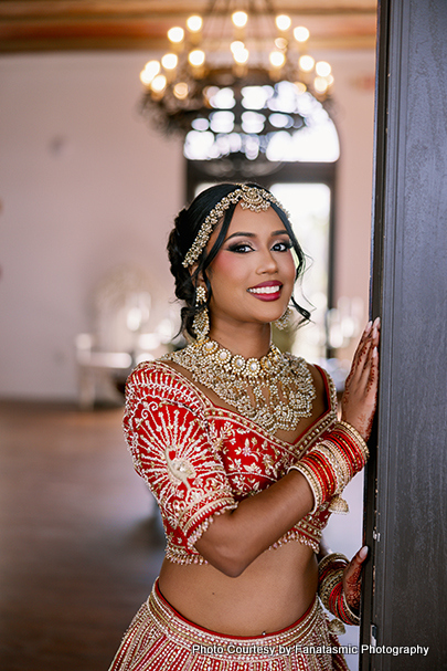 Kashmira in bridal lehenga with intricate jewelry and henna