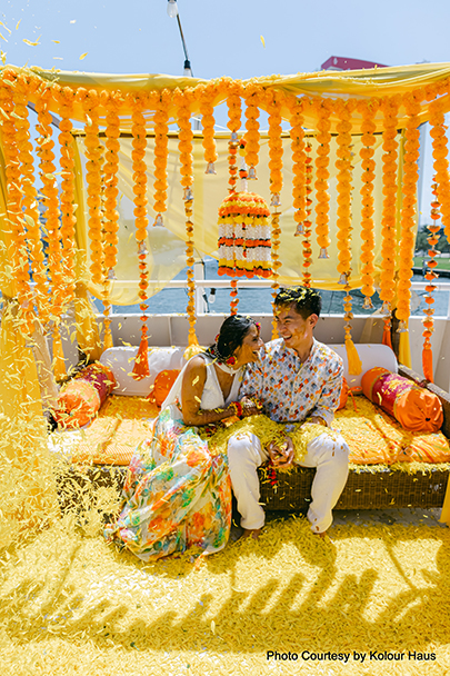 Navya and Eddy celebrating their Haldi ceremony aboard the marigold-decked 'S.S. Haldi' yacht