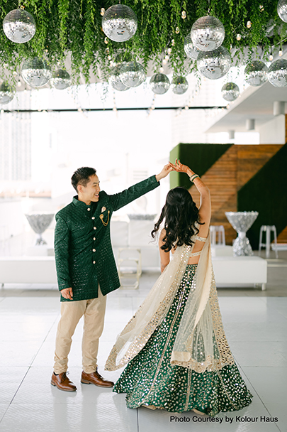 Navya and Eddy dancing under disco balls during their 'Disco in Paradise' themed Sangeet at a rooftop penthouse