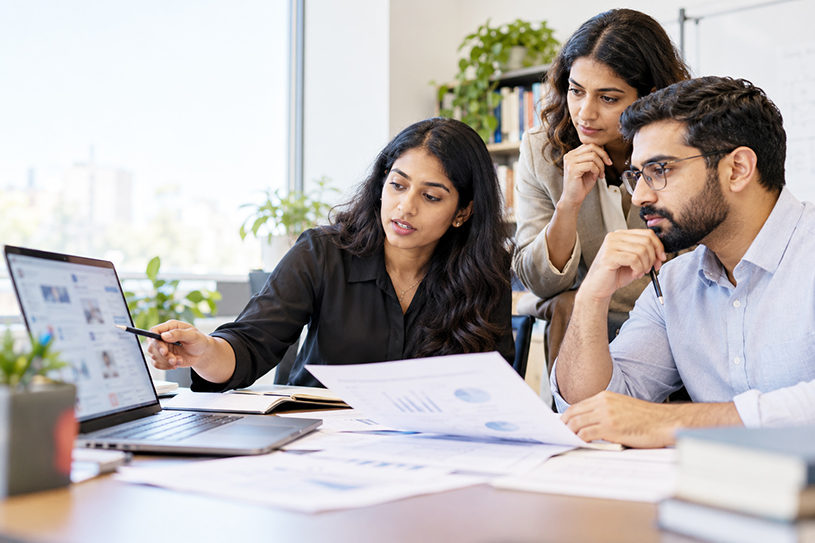 Research team reviewing studies on online harassment targeting South Asian Americans