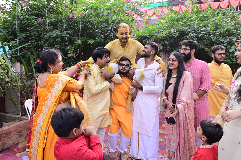 Friends and family joyfully celebrating haldi ceremony at Aneesh and Priyanka’s wedding in Prayagraj