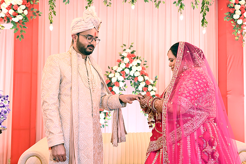 Aneesh and Priyanka exchanging rings during their traditional Indian wedding ceremony in Prayagraj