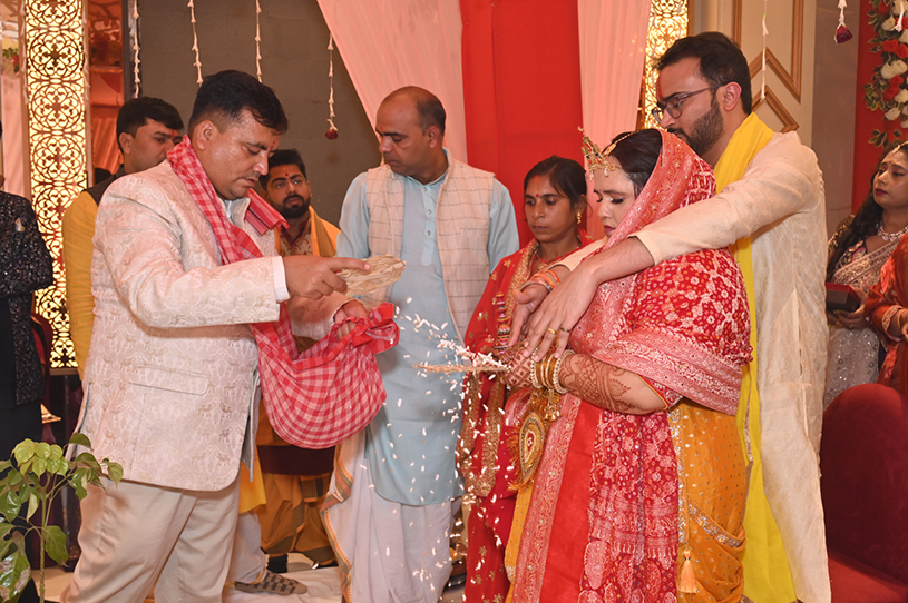 Family members blessing Aneesh and Priyanka during traditional Hindu wedding ceremony in Prayagraj