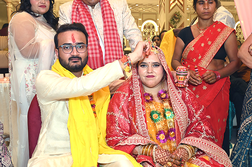 Aneesh applying sindoor to Priyanka during traditional Indian wedding ceremony in Prayagraj